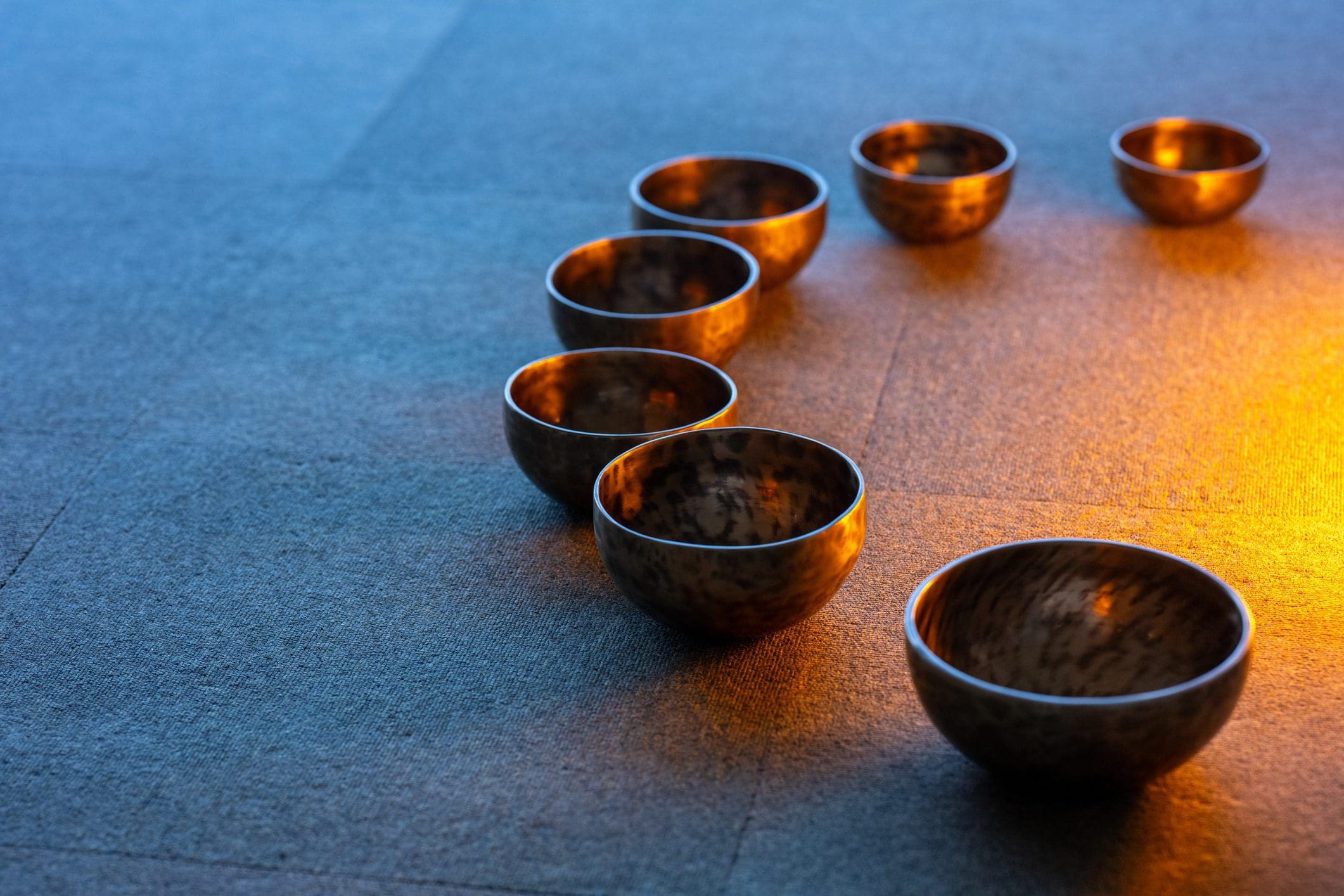 Seven bowls arranged in a semicircle pattern.